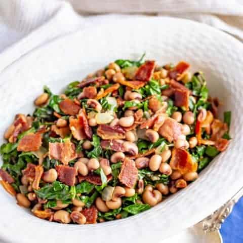 Collard greens and beans with bacon are a favorite Southern recipe, made quick and easy here with a few shortcuts. It’s great for a New Year’s Day meal or an anytime dinner side dish! #collards #beans #fieldpeas #sidedish #newyearsfood