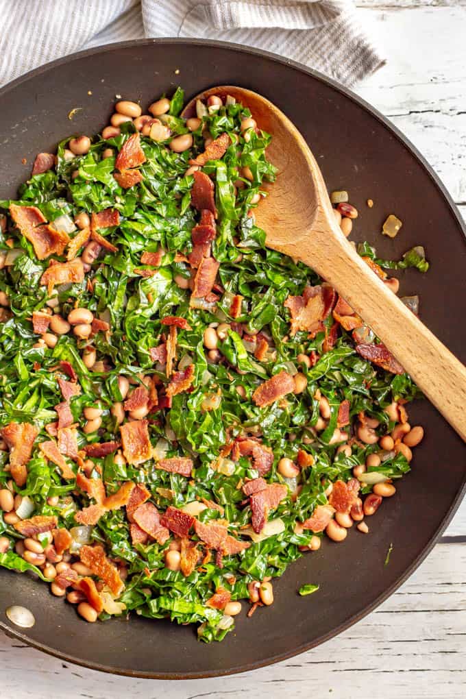 Collard greens and beans with bacon are a favorite Southern recipe, made quick and easy here with a few shortcuts. It’s great for a New Year’s Day meal or an anytime dinner side dish! #collards #beans #fieldpeas #sidedish #newyearsfood