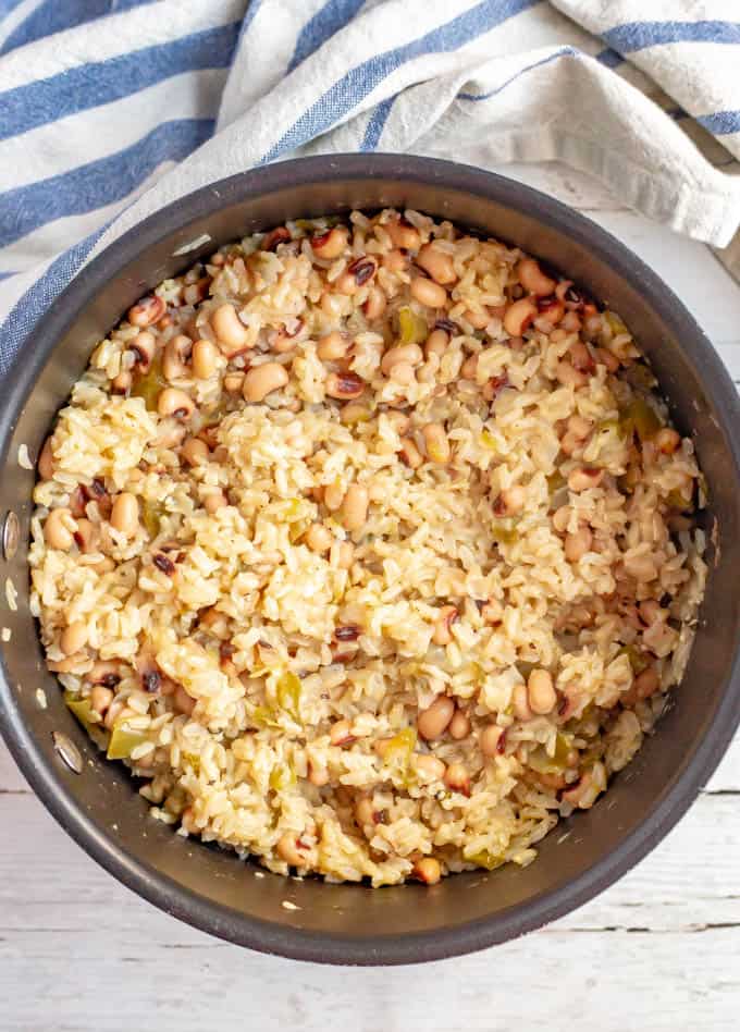 Cooked brown rice and black-eyed peas mixed together in a pan