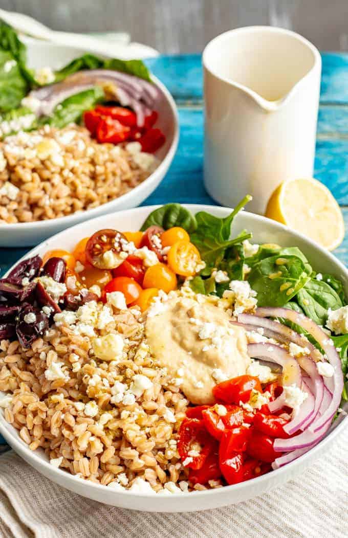 Vegetarian Greek grain bowls are loaded with wholesome grains and veggies and topped with an easy red wine vinaigrette for a beautiful and delicious lunch or light dinner! #grainbowl #mealprep #vegetarian #lunchideas #mediterraneanfood