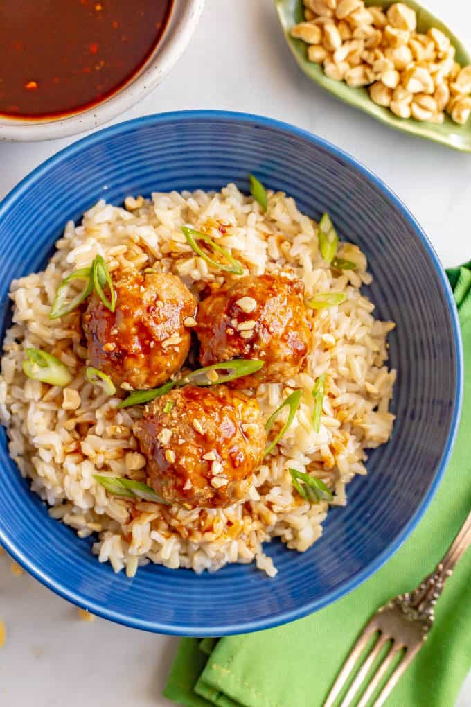 Baked Asian turkey meatballs with hoisin sauce and brown rice in a blue bowl