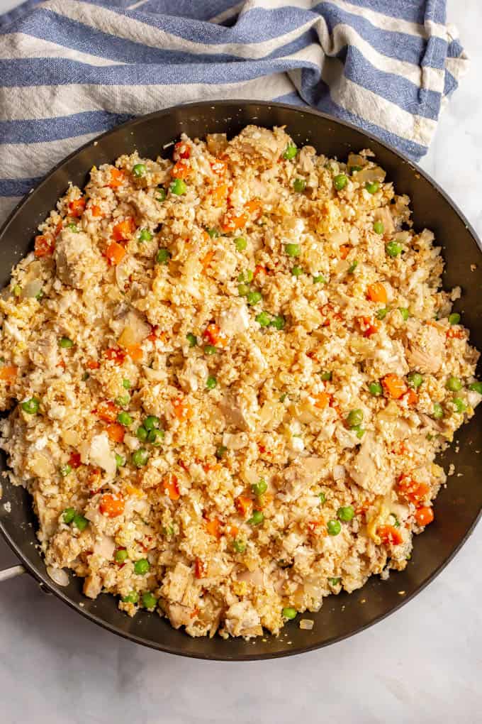 Cauliflower fried rice with chicken in a large skillet