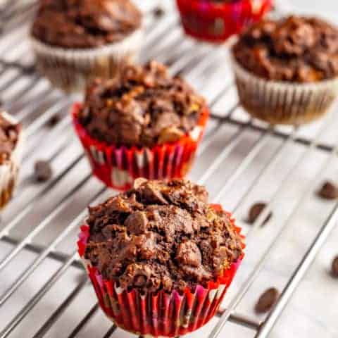 Double chocolate banana muffins are moist, full of melty chocolate chips and perfect for snacking! They’re also whole wheat and naturally sweetened, with no added sugar. #muffins #chocolatelover #bananachocolate #ripebananas