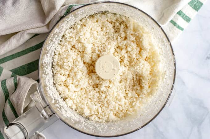 Cauliflower in a food processor after being pulsed and broken down