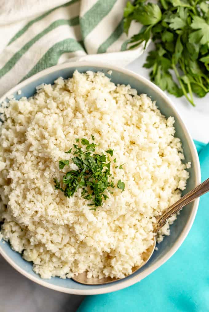 Cauliflower rice is quick and easy to make at home and is great for a healthy, low-carb side dish. It’s naturally gluten-free and great for vegan, paleo and whole-30 eating. #cauliflower #lowcarb #paleorecipes #whole30recipes