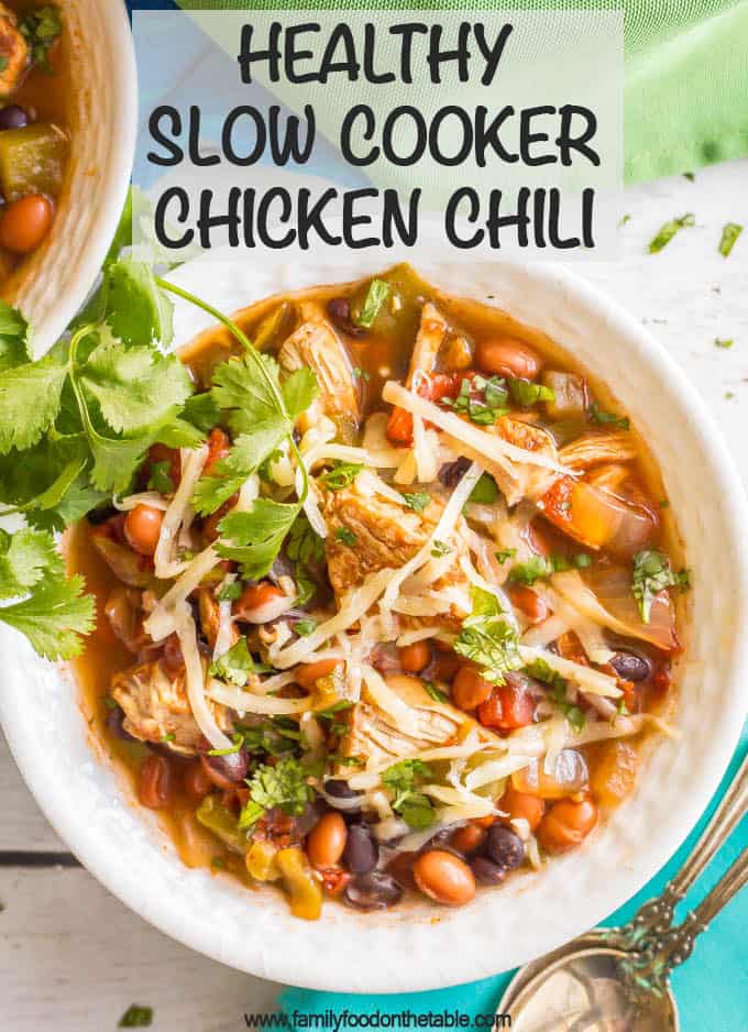 Healthy slow cooker chicken chili is easy to prep and loaded with peppers, beans, tender chunks of chicken and plenty of delicious spices. Add your favorite toppings, grab a spoon and dig into a warm bowl of this chili! #chickenchili #slowcooker #chickendinner #chickenrecipes #chili