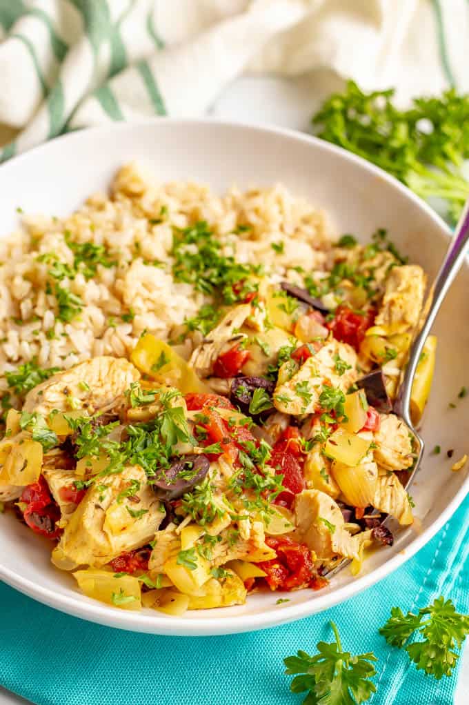 Slow cooker Mediterranean chicken is quick and easy to prep and bursting with bright, healthy flavors. This meal is loaded with tomatoes, artichokes and olives and goes great with rice or couscous. #slowcooker #chickendinner #easychickenrecipes #mediterraneanchicken