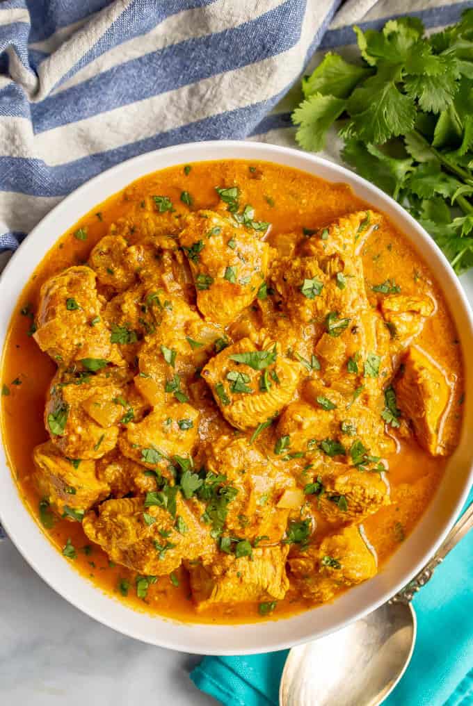 Healthy butter chicken with tomato sauce made with Greek yogurt served in a white bowl