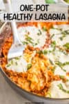 A serving spoon resting in a large skillet full of a lasagna mixture topped with melted fresh mozzarella and julienned basil and a text overlay on the photo.