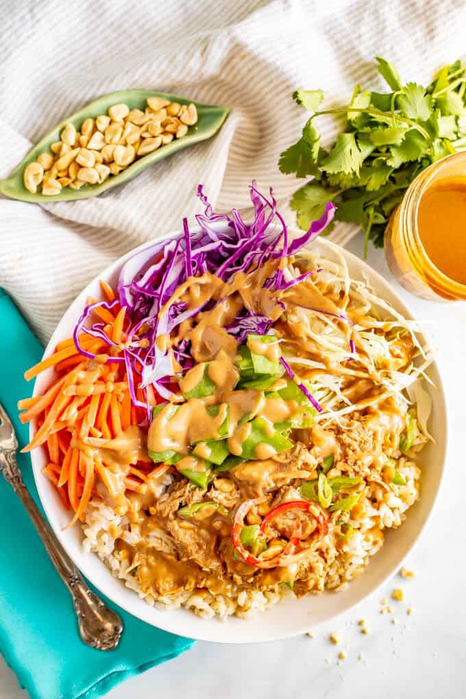 Peanut chicken rice and cabbage bowls are a crunchy, colorful and delicious way to serve peanut chicken. They’re drizzled with an easy but irresistible peanut dressing. #peanutchicken #ricebowls #veggiebowls #mealprep