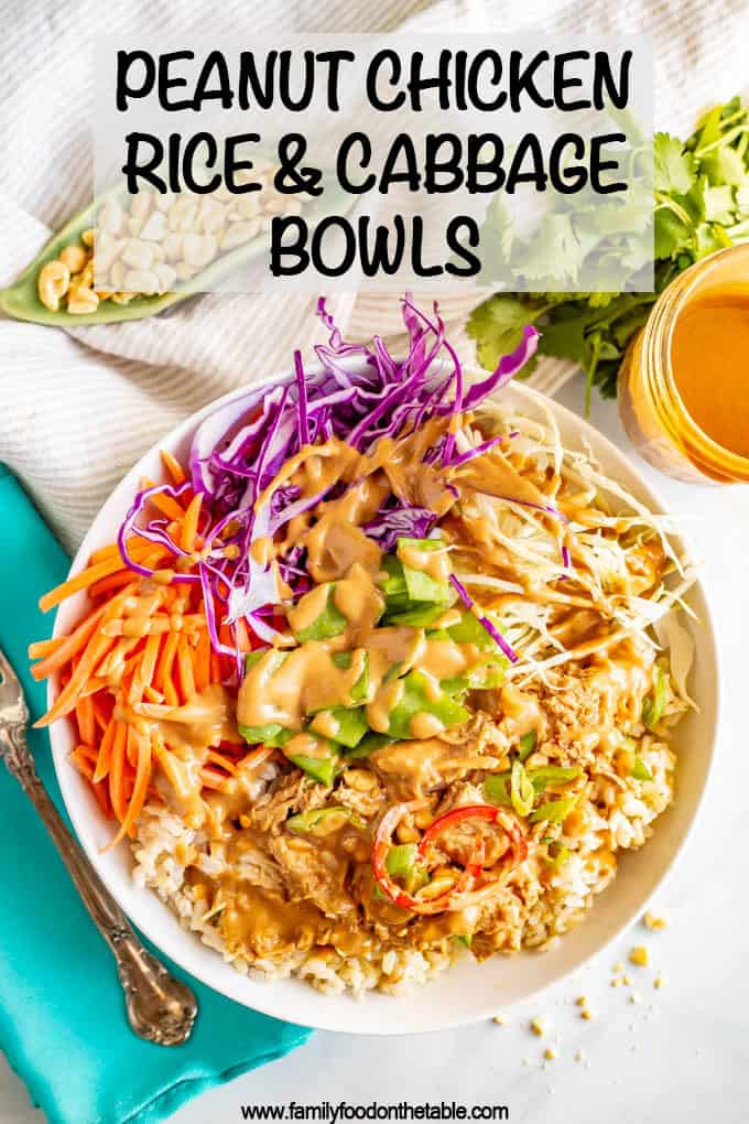 A rice bowl with peanut chicken with cabbage and veggies with a peanut sauce drizzled on top.