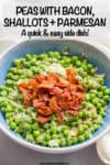 A blue bowl full of green peas topped with Parmesan cheese and crumbled bacon pieces.