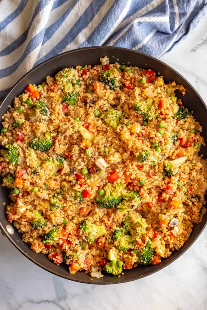 Vegetarian quinoa fried rice cooked in a large saute pan