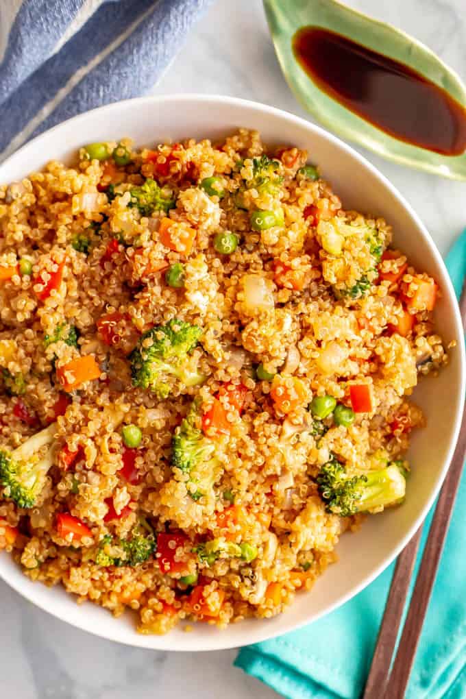 This vegetarian quinoa fried rice is quick and easy to make and loaded with fluffy quinoa and tender veggies. This 20-minute recipe is perfect for a meatless weeknight dinner! #friedrice #quinoa #vegetarianrecipes #easyvegetariandinners