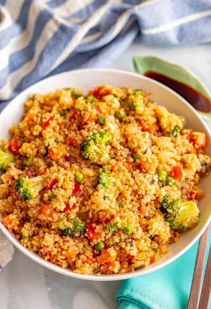 This vegetarian quinoa fried rice is quick and easy to make and loaded with fluffy quinoa and tender veggies. This 20-minute recipe is perfect for a meatless weeknight dinner! #friedrice #quinoa #vegetarianrecipes #easyvegetariandinners