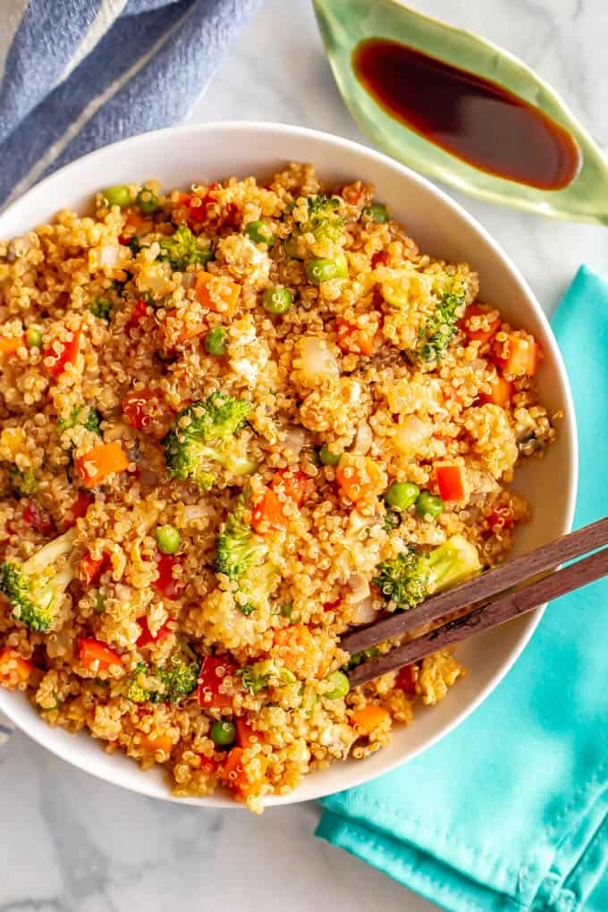 This vegetarian quinoa fried rice is quick and easy to make and loaded with fluffy quinoa and tender veggies. This 20-minute recipe is perfect for a meatless weeknight dinner! #friedrice #quinoa #vegetarianrecipes #easyvegetariandinners