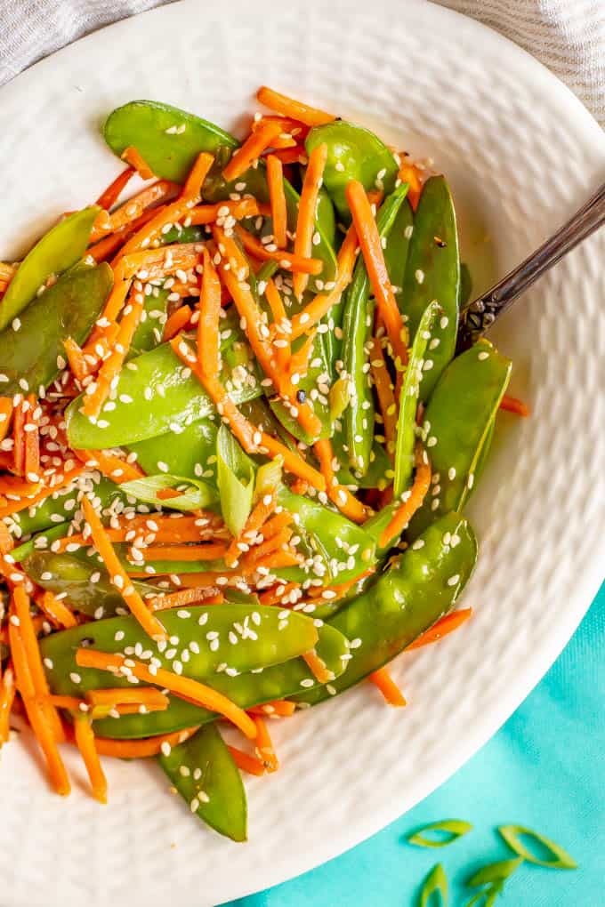 Sesame snow peas and carrots is a quick and easy side dish that’s ready in just 10 minutes! You’ll love how colorful and tasty this recipe is for a quick weeknight veggie side! #snowpeas #carrots #sidedish #easysides #glutenfreerecipes