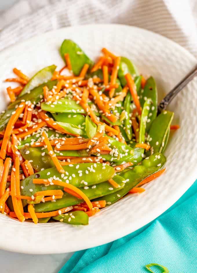 Sesame snow peas and carrots is a quick and easy side dish that’s ready in just 10 minutes! You’ll love how colorful and tasty this recipe is for a quick weeknight veggie side! #snowpeas #carrots #sidedish #easysides #glutenfreerecipes