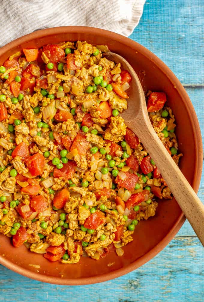 Curry turkey and peas with tomatoes cooked in a large skillet