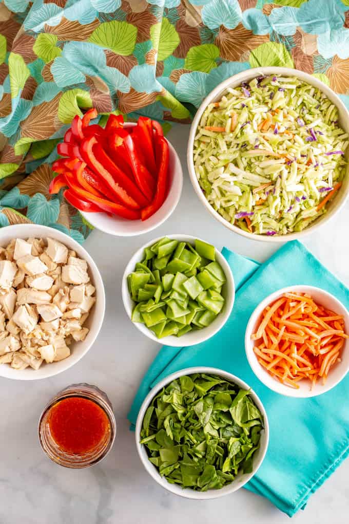 Ingredients for broccoli slaw salad laid out in separate bowls