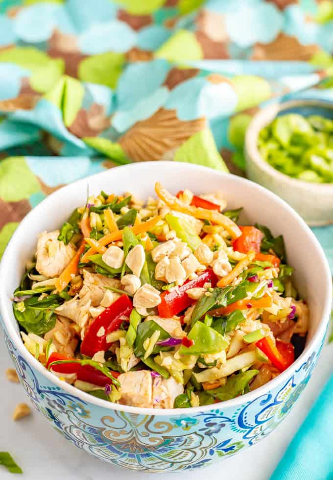 Asian style broccoli slaw salad served in a large bowl with chopped peanuts