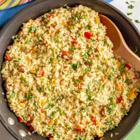 Confetti rice is a fun mix of fluffy brown rice and colorful bell peppers that’s great as a side dish or for tacos or grain bowls. Add your favorite toppings and enjoy! #rice #sidedish #easyrecipe #healthyrecipes