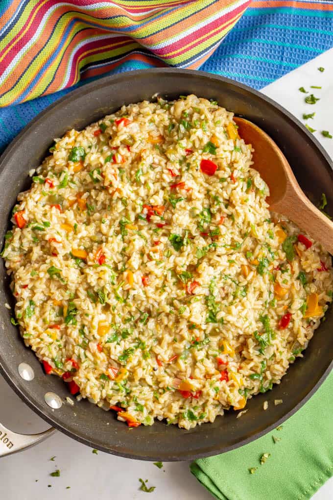 Confetti rice is a fun mix of fluffy brown rice and colorful bell peppers that’s great as a side dish or for tacos or grain bowls. Add your favorite toppings and enjoy! #rice #sidedish #easyrecipe #healthyrecipes