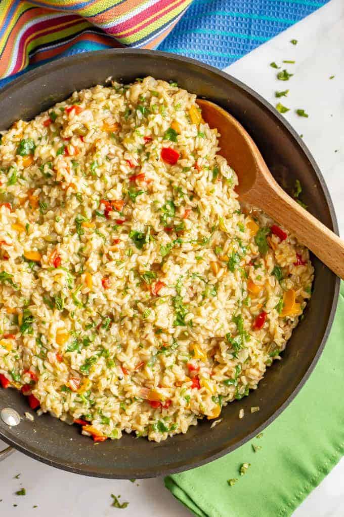 Confetti rice is a fun mix of fluffy brown rice and colorful bell peppers that’s great as a side dish or for tacos or grain bowls. Add your favorite toppings and enjoy! #rice #sidedish #easyrecipe #healthyrecipes