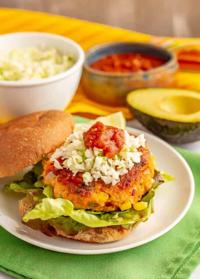 Southwest salmon burgers are full of fun mix-ins and tasty seasonings plus have lots of great topping options too! Great for a delicious, healthy burger at lunch or dinner. #salmon #seafood #burgers