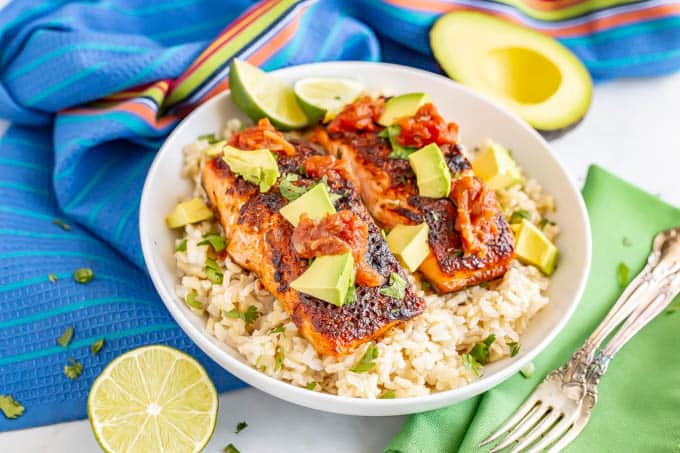 Roasted southwestern salmon filets on a bed of rice topped with avocado chunks and salsa