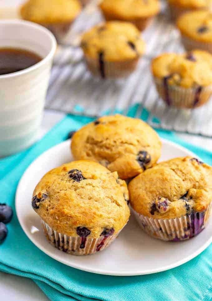 Healthy blueberry muffins and so light and fluffy and bursting with juicy blueberries! These muffins are whole wheat, naturally sweetened and perfect for a yummy, healthy breakfast! #breakfast #muffins #blueberries #blueberrymuffins