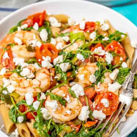 Shrimp pasta with tomatoes, arugula, scallions and feta cheese
