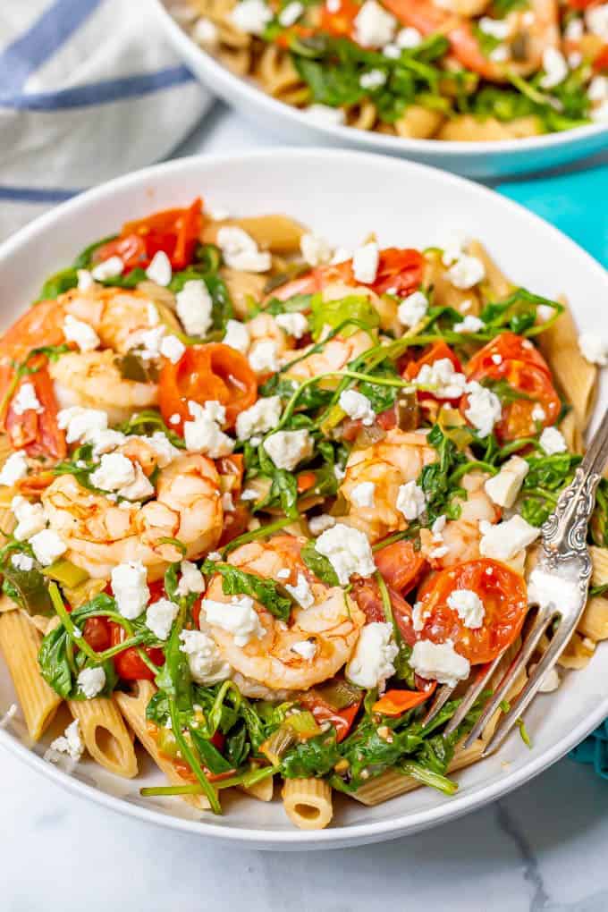 Shrimp pasta with tomatoes, arugula, scallions and feta cheese