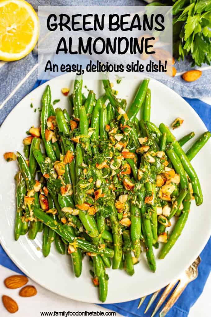 Green beans served on a plate with a sprinkling of almonds mixed with parsley and lemon juice