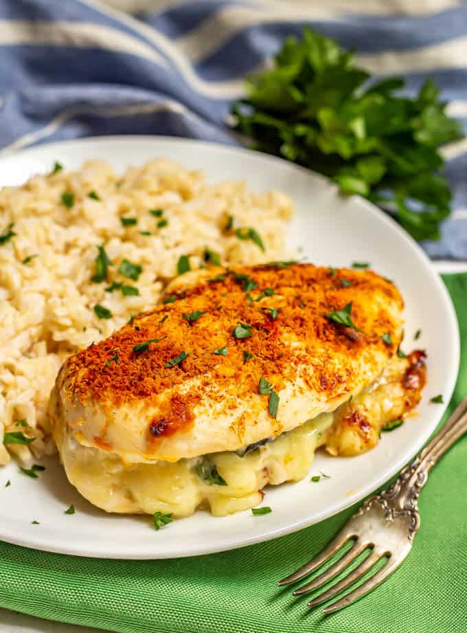 Baked stuffed chicken breast with spinach and mozzarella cheese served with brown rice