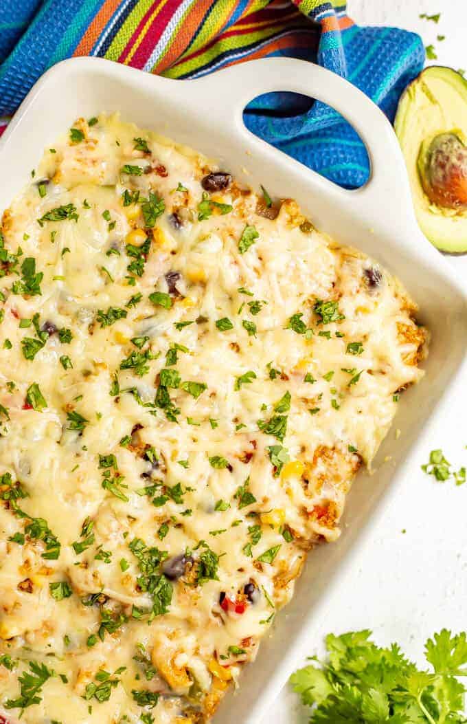 Cheesy Mexican chicken quinoa casserole is loaded with black beans, tomatoes, corn and peppers, plus plenty of cheese, for a delicious and healthy family dinner! (It’s also gluten-free and easy to make ahead!) #chickendinner #chickenrecipes #casserole #glutenfreerecipes #healthydinners