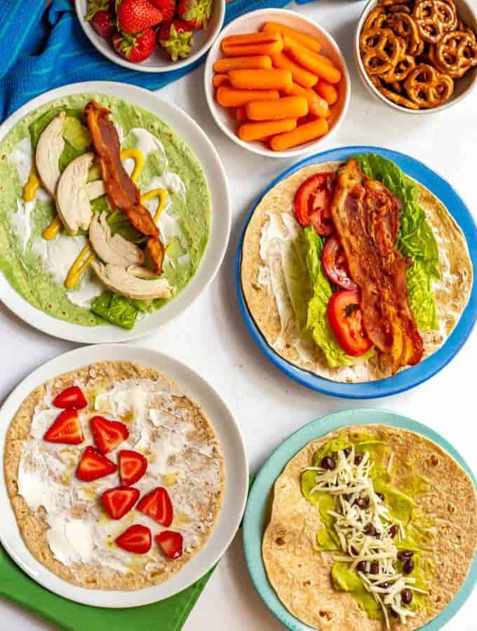 Healthy roll up lunch wraps includes tons of ideas for classic wraps, peanut butter wraps, hummus wraps and more! Great for school lunchbox ideas for the kids or to take to the office. #healthylunch #lunchideas #lunchbox #schoollunch #healthywraps #wraps
