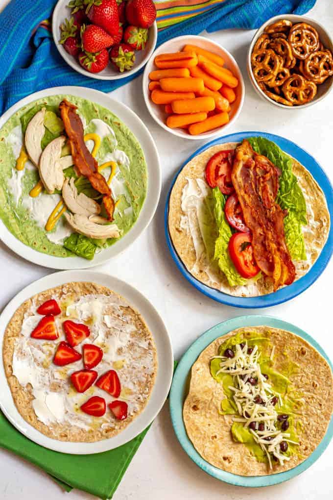 Healthy roll up lunch wraps includes tons of ideas for classic wraps, peanut butter wraps, hummus wraps and more! Great for school lunchbox ideas for the kids or to take to the office. #healthylunch #lunchideas #lunchbox #schoollunch #healthywraps #wraps