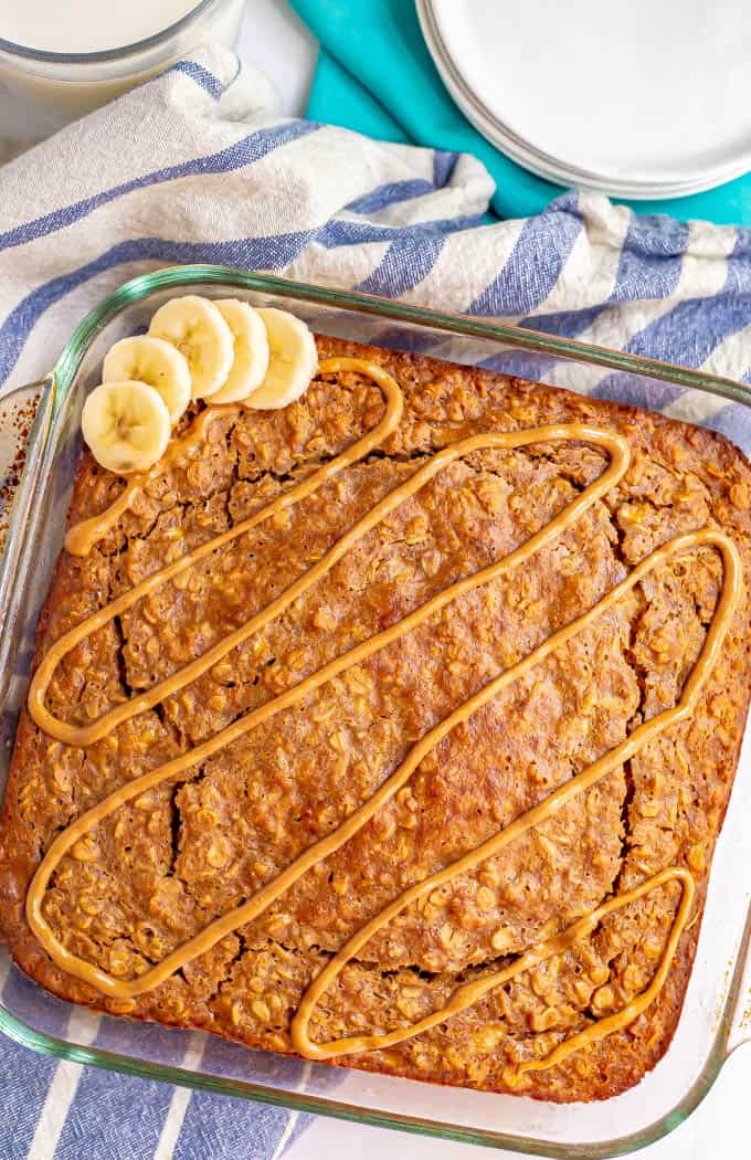 Peanut butter oatmeal baked in a glass pan and topped with a drizzle of peanut butter