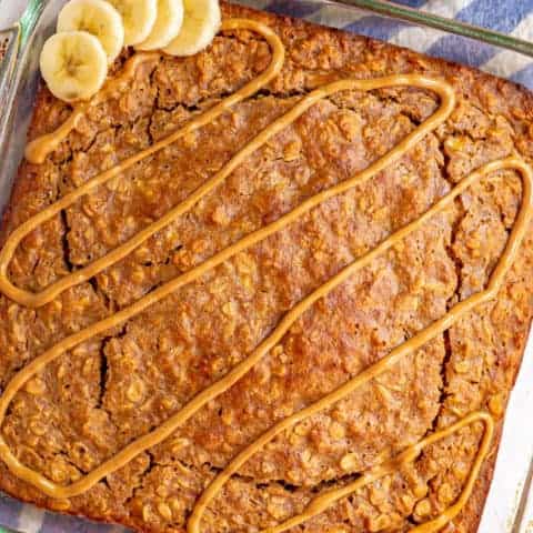 Glass pan with peanut butter baked oatmeal and a drizzle of peanut butter on top