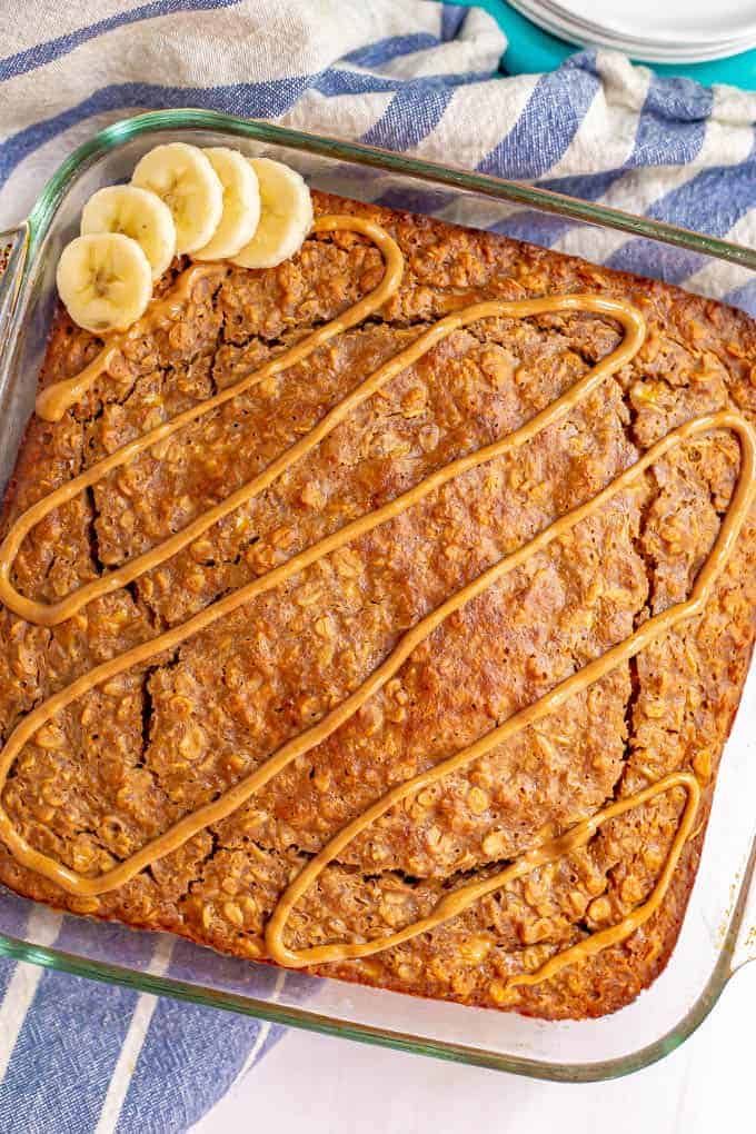 Glass pan with peanut butter baked oatmeal and a drizzle of peanut butter on top