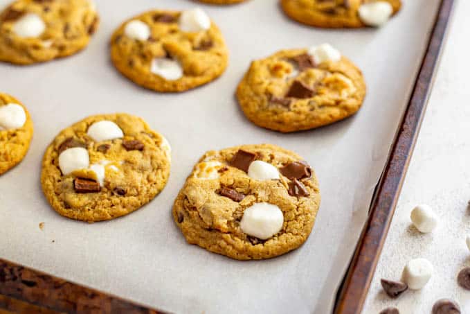 Close up of a baked cookie with chocolate and marshmallows on a baking sheet