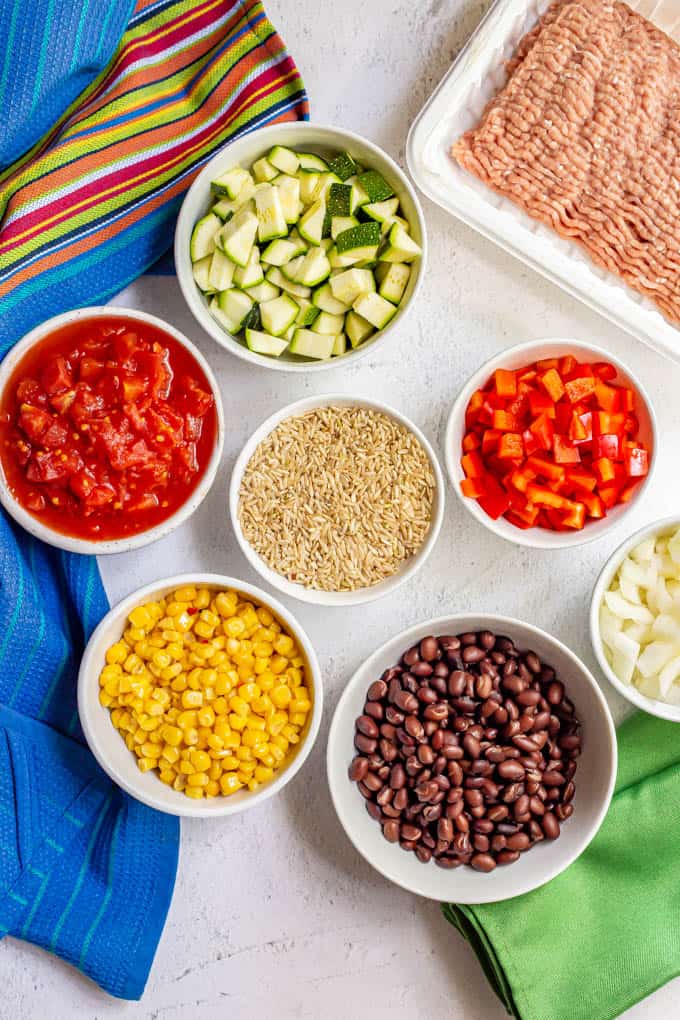 Ingredients laid out in separate bowls to make turkey taco rice skillet