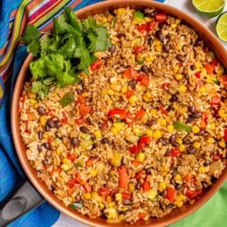 A skillet of turkey, rice, beans, corn, peppers and cilantro for garnish