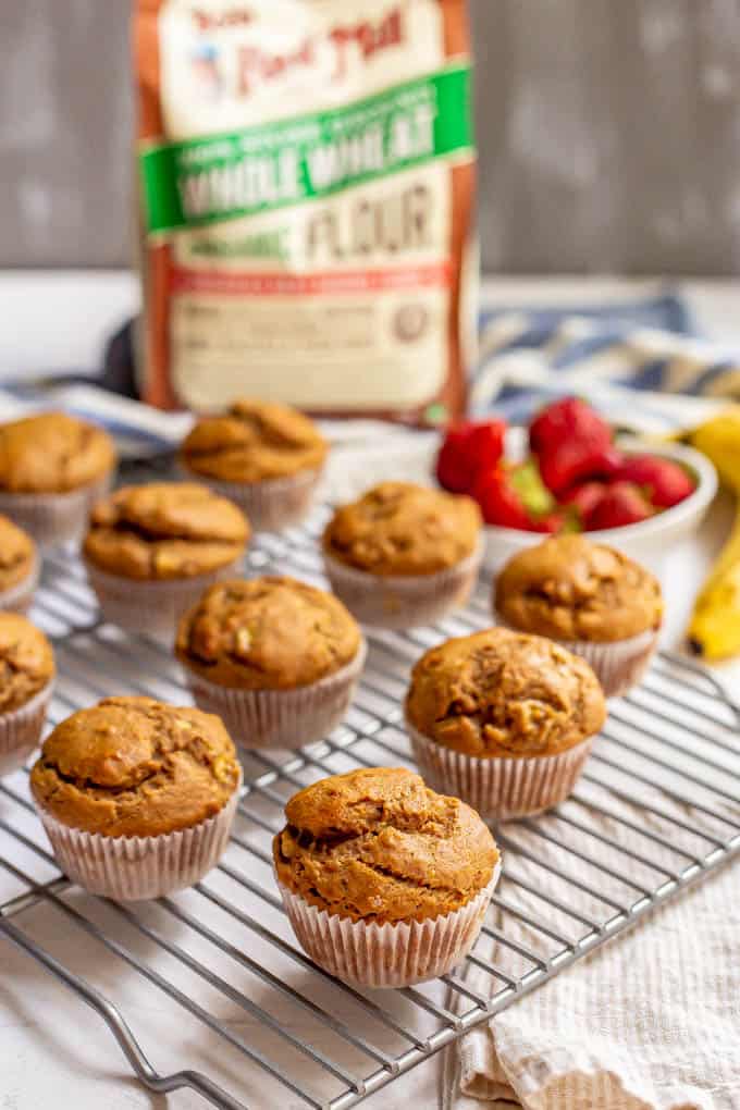 Healthy peanut butter banana muffins on a cooling rack with a bag of flour in the background