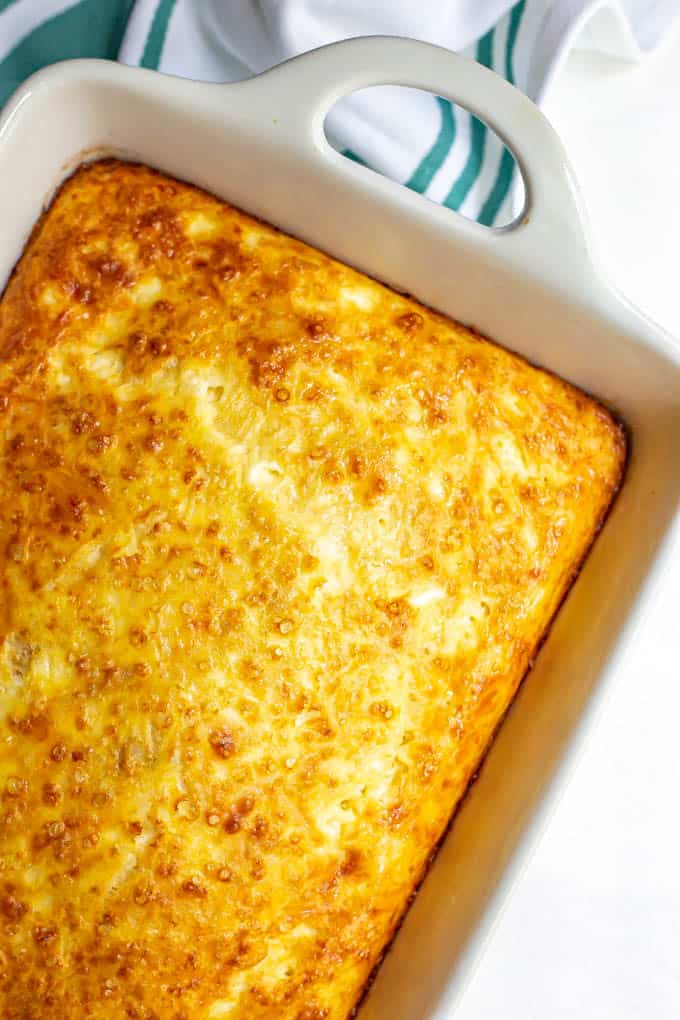 Baked eggs with cheese in a large white casserole dish