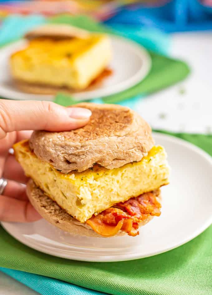 English muffin breakfast sandwich with cooked eggs and bacon