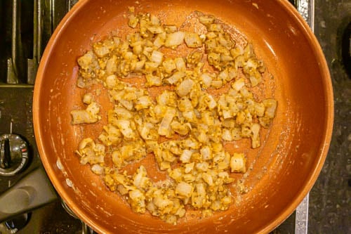 Sautéed onions with spices and flour in a large pan