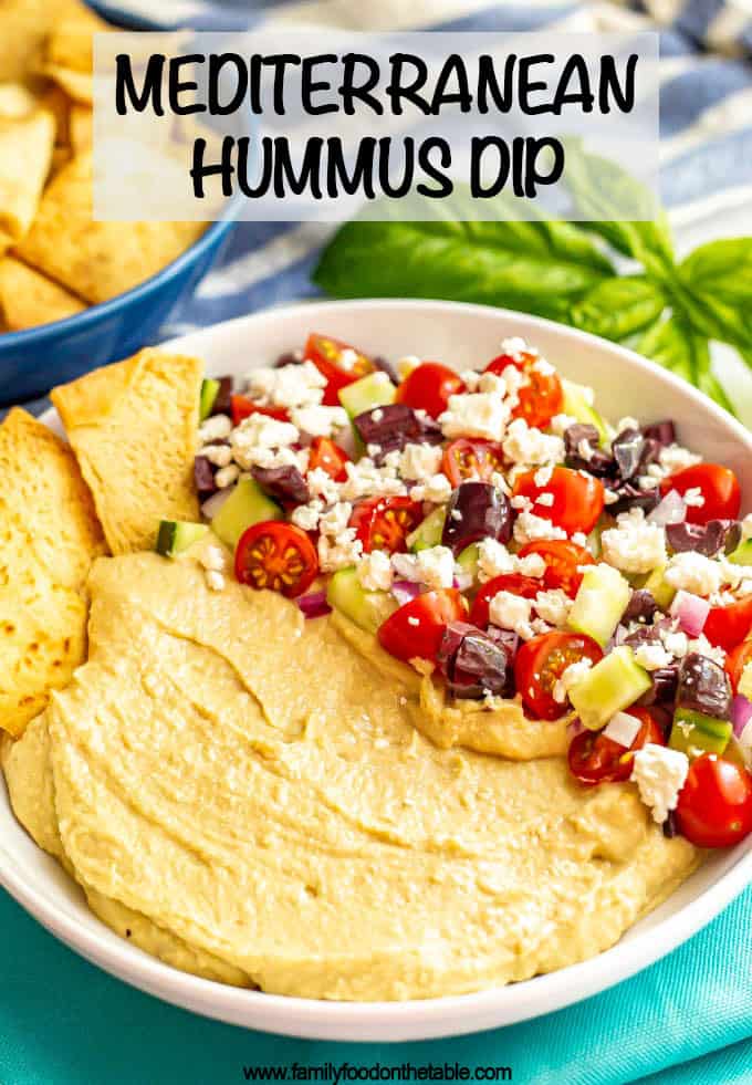 Mediterranean layered hummus dip is creamy, colorful and loaded with fresh flavors. This easy appetizer is quick to put together, can be made ahead and goes great with pita chips! #hummus #appetizer #mediterraneanfood #hummusdip #partyfood #gamedayeats