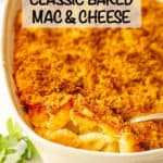 Baked mac and cheese in a white casserole dish with a browned buttery breadcrumb topping.